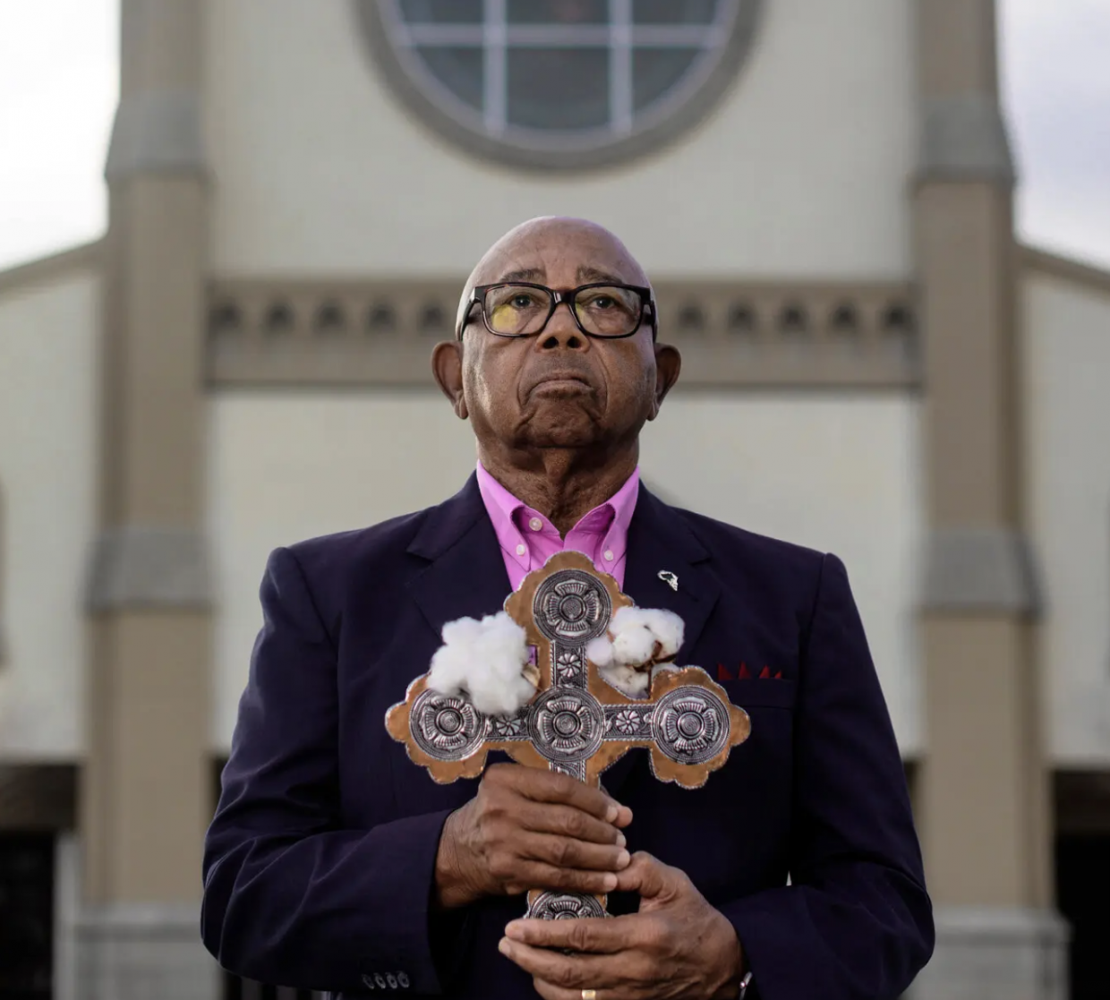 Descendant Joseph Stewart holding cross with cotton