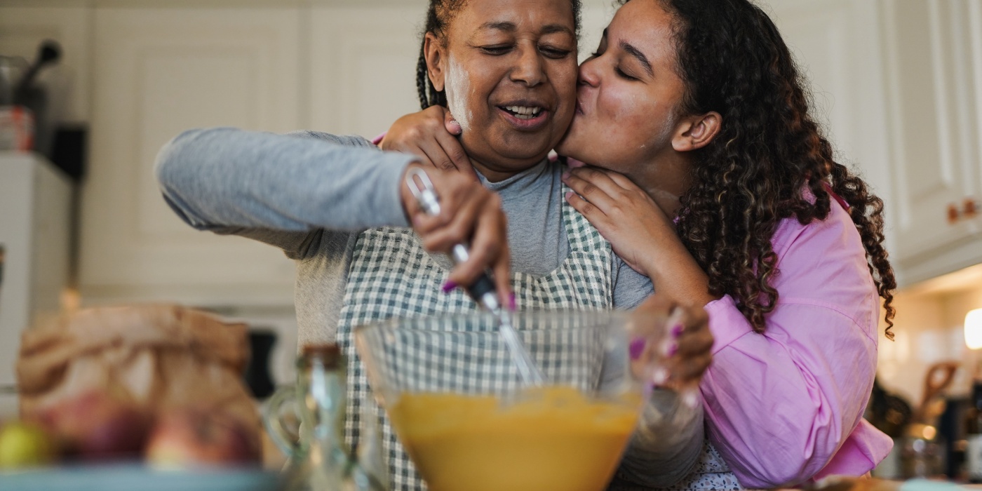 Elderly woman and daughter baking